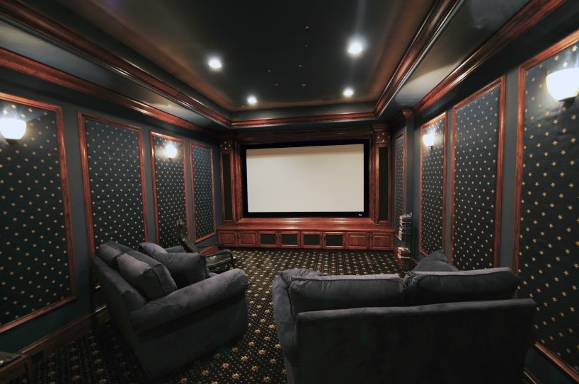 Media Room in a home with comfortable seating and projector screen